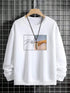 White crewneck sweatshirt with artistic graphic print and relaxed fit, displayed on hanger.