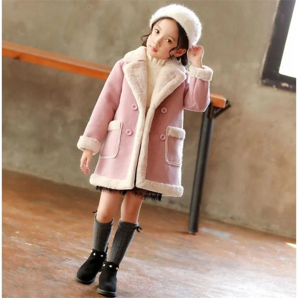 Girl wearing a pink faux fur winter coat with white trim and a cozy fit indoors