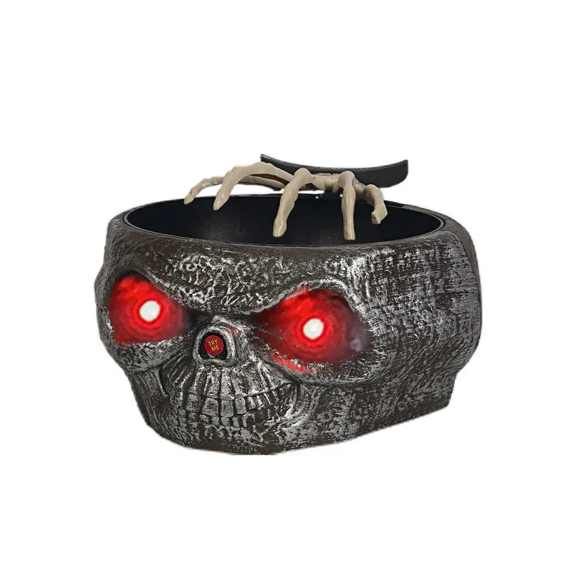 Skull-shaped candy bowl with glowing red eyes and skeleton hand, Halloween decoration.