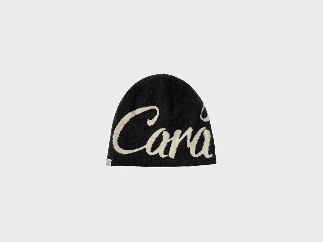 Black knit beanie with bold white script, soft texture, streetwear winter hat