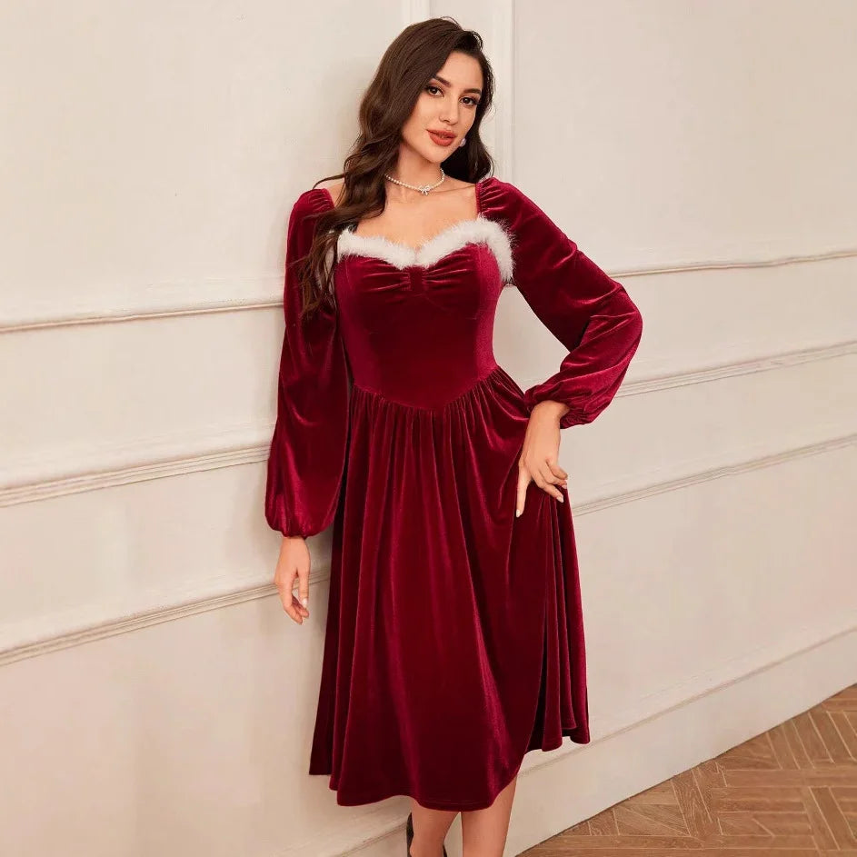 Woman wearing a red velvet midi dress with long sleeves and white faux fur trim, fit and flare style