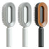 Modern oval hair brushes in white, grey, and orange with ergonomic handles and sleek design