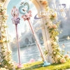 Pink and purple pastel magic wands with heart crowns, set in floral garden with castle backdrop