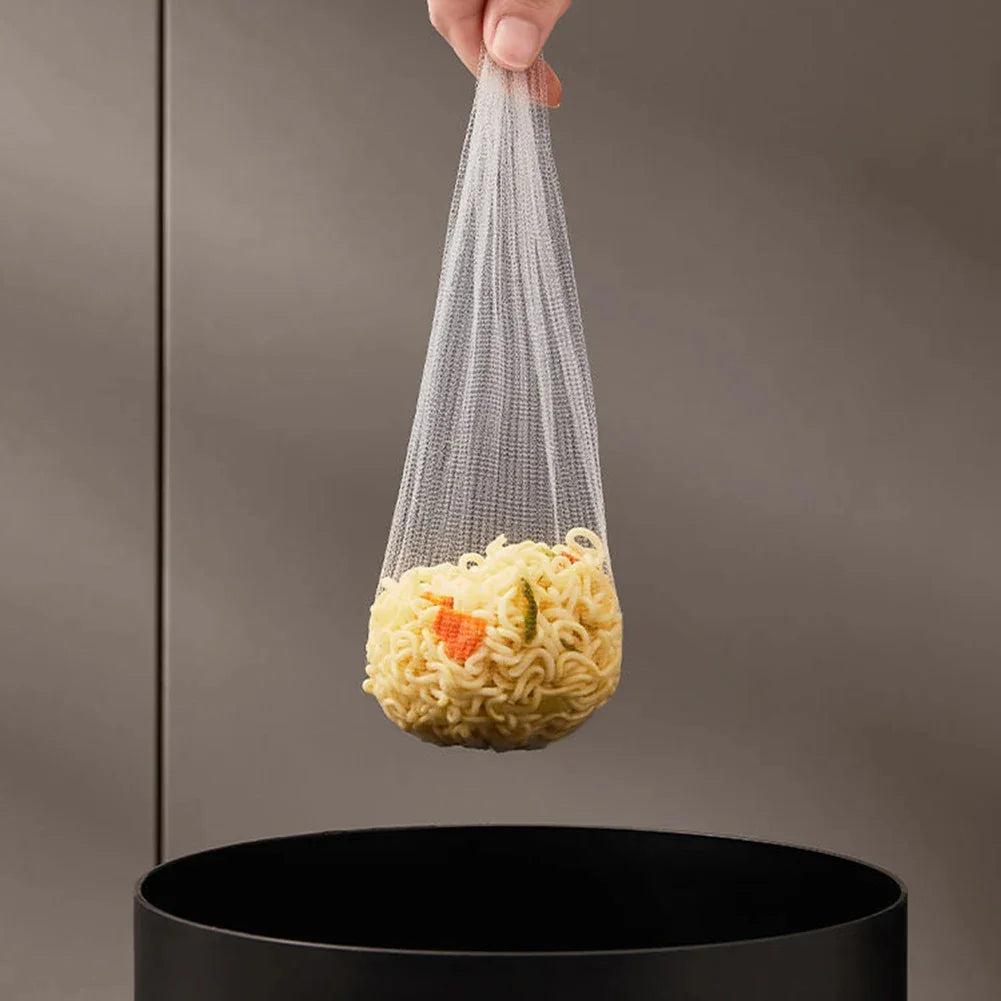Hand holding a mesh strainer bag with cooked noodles over a black pot
