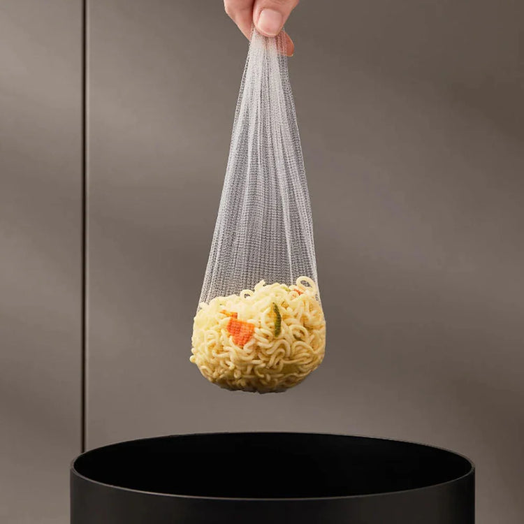 Hand holding a mesh strainer bag with cooked noodles over a black pot