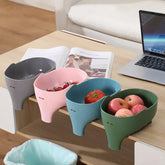 Colorful plastic snack or fruit bowls clipped to table edge, assorted fruits inside, modern home decor