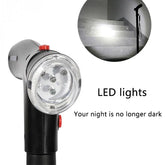 Close-up of black walking cane with built-in LED lights, shown illuminating stairs in the dark.