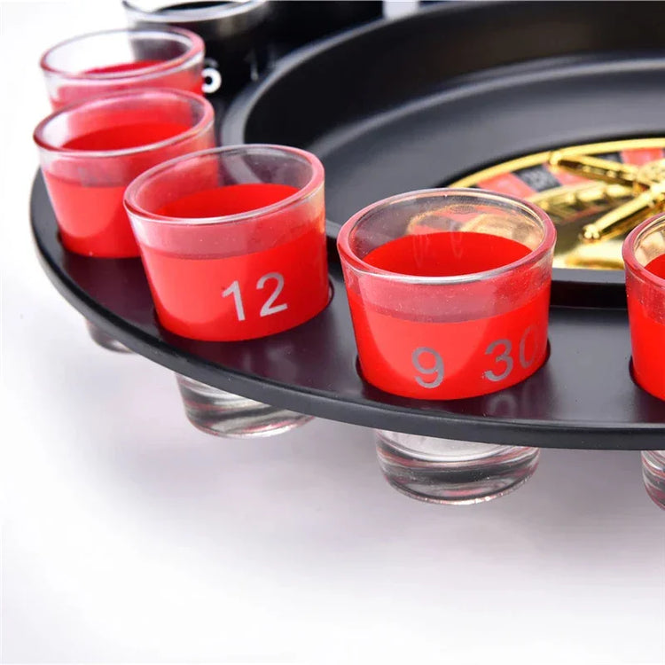 Close-up of red shot glasses with numbers on a black party roulette drinking game tray