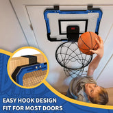 Kid in grey short sleeve shirt playing indoor basketball, blue backboard, relaxed fit.