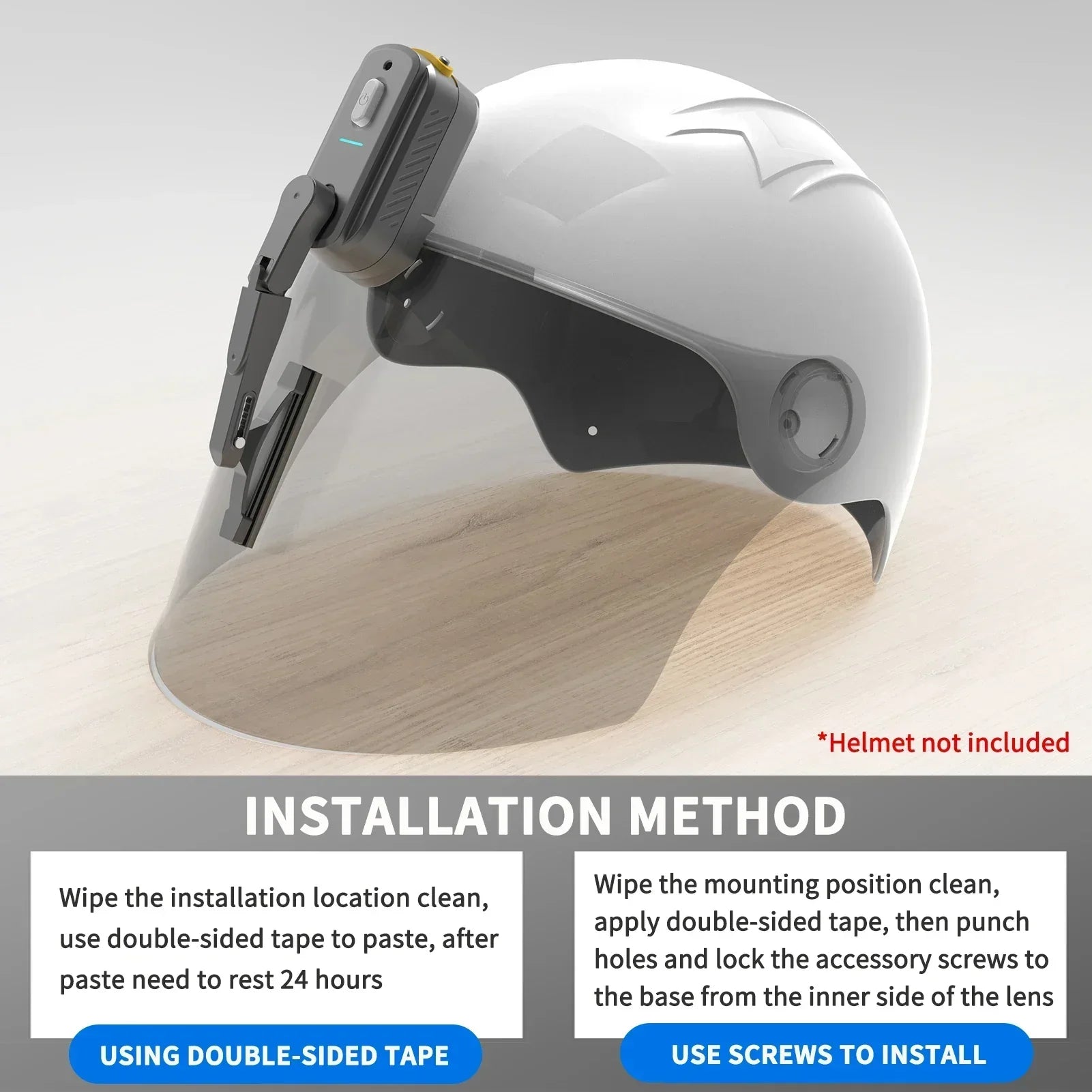 Gray helmet visor with attached electronic device and wiper on a wood surface, installation guide shown