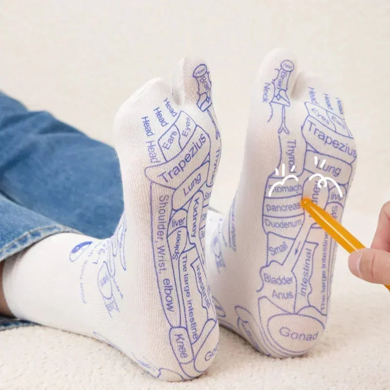 White anatomical print toe socks with blue reflexology design, worn with casual jeans.