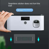 Hand holding modern wall-mounted device with seamless adhesive, easy wall installation