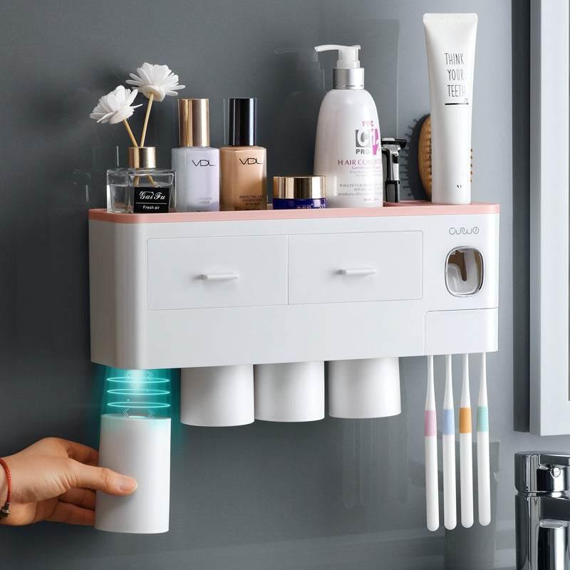 Wall-mounted white bathroom organizer with cups, drawers, and toothbrush holders