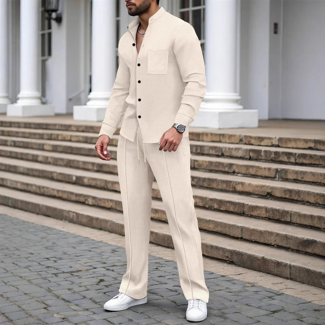 Man wearing beige textured button-up shirt and matching drawstring pants, relaxed fit, streetwear style