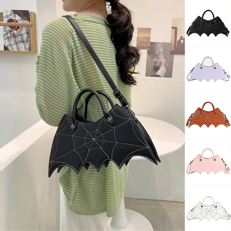 Woman wearing a green striped top with a black faux leather spiderweb handbag, bat wing shape, crossbody fit.