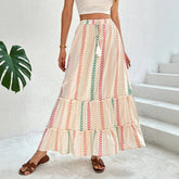 Woman wearing a flowy cream maxi skirt with colorful vertical chevron stripes, relaxed fit