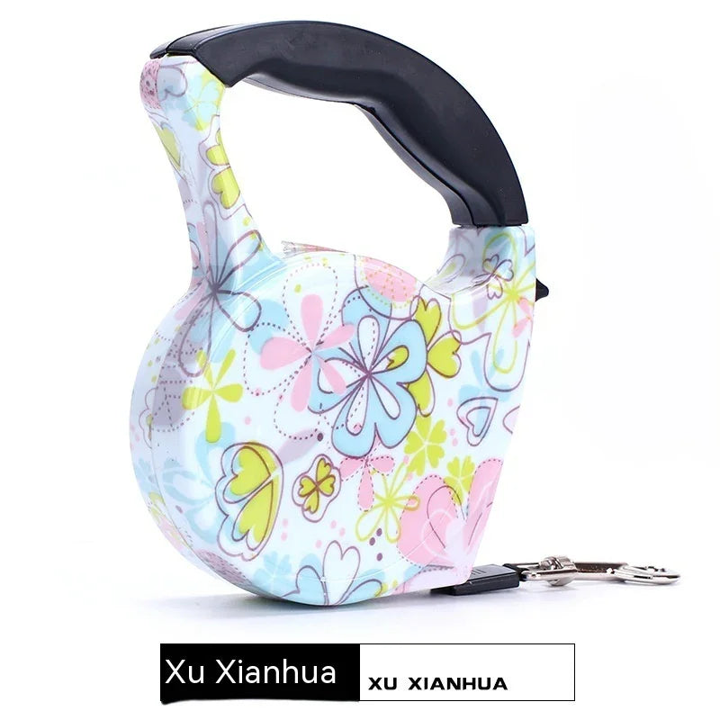 Colorful floral retractable dog leash with ergonomic black handle and metal clasp