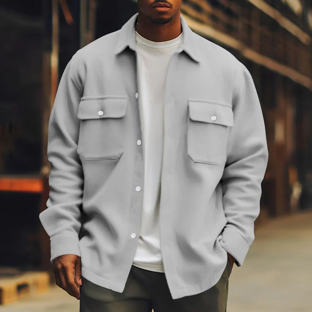 Man wearing a relaxed fit light gray overshirt with chest pockets and a white tee