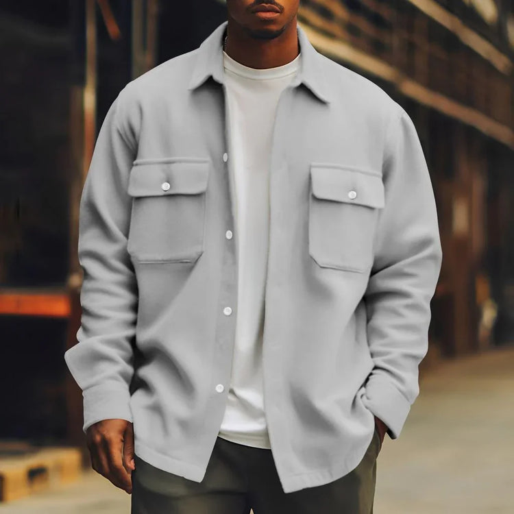 Man wearing a relaxed fit light gray overshirt with chest pockets and a white tee