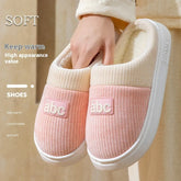 Cozy pink and cream slip-on slippers with soft textured fabric and plush lining