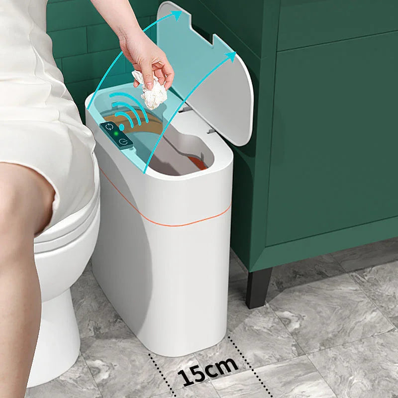Woman in white dress using a sensor automatic trash can with touchless lid in modern bathroom.