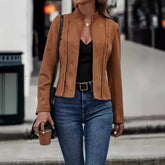 Woman wearing a fitted brown suede jacket, black top, and high-waisted blue jeans.