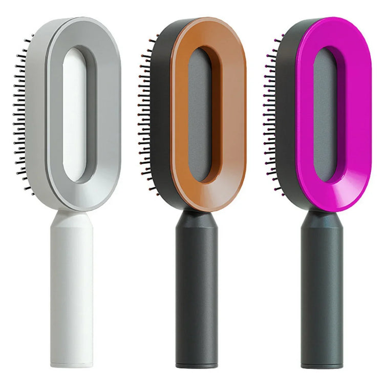 Three futuristic oval hair brushes in gray, brown, and magenta with ergonomic handles