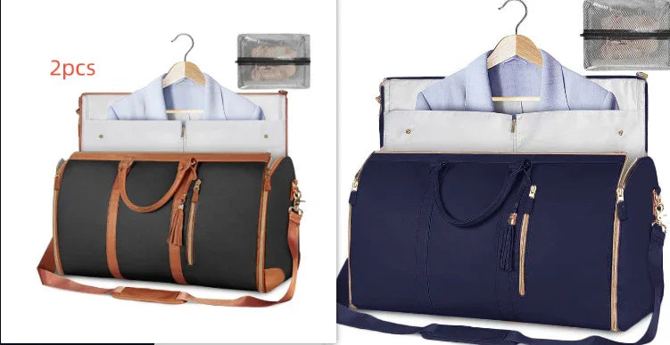 Two large duffel bags in black and navy, with leather accents, displayed open showing suit storage and hanging shirts, ideal for travel organization.
