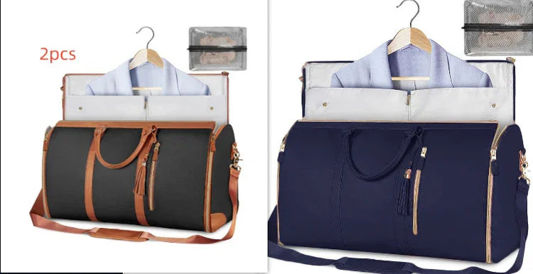 Two large duffel bags in black and navy, with leather accents, displayed open showing suit storage and hanging shirts, ideal for travel organization.