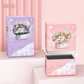 Pastel pink and purple gift boxes with floral bouquet illustrations on a soft pink background.