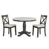 Round wooden table with pedestal base and two cushioned dining chairs, modern rustic style
