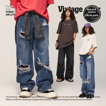 Unisex oversized ripped jeans in blue and black denim, distressed streetwear style, loose fit.
