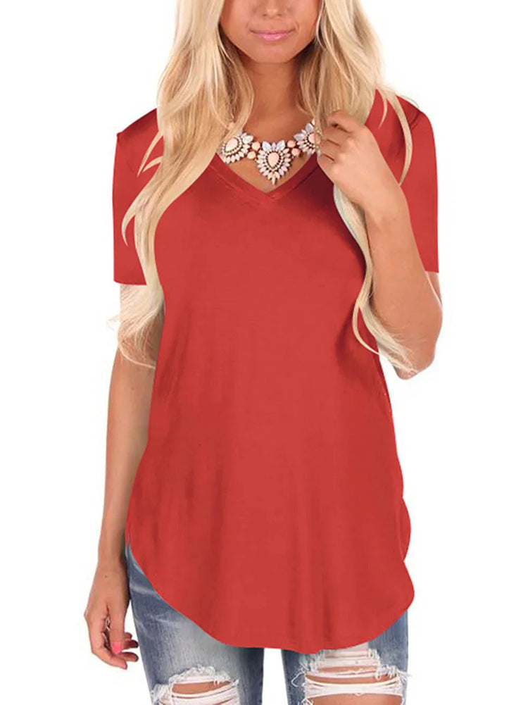 Woman wearing a loose-fit red V-neck short sleeve t-shirt and distressed blue jeans