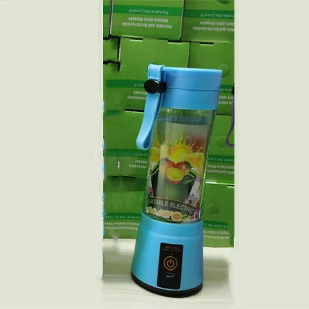 Blue portable electric blender with transparent cup and handle, modern tech accessory