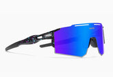 Futuristic streetwear sunglasses with large blue mirrored lens and black splatter-print frame