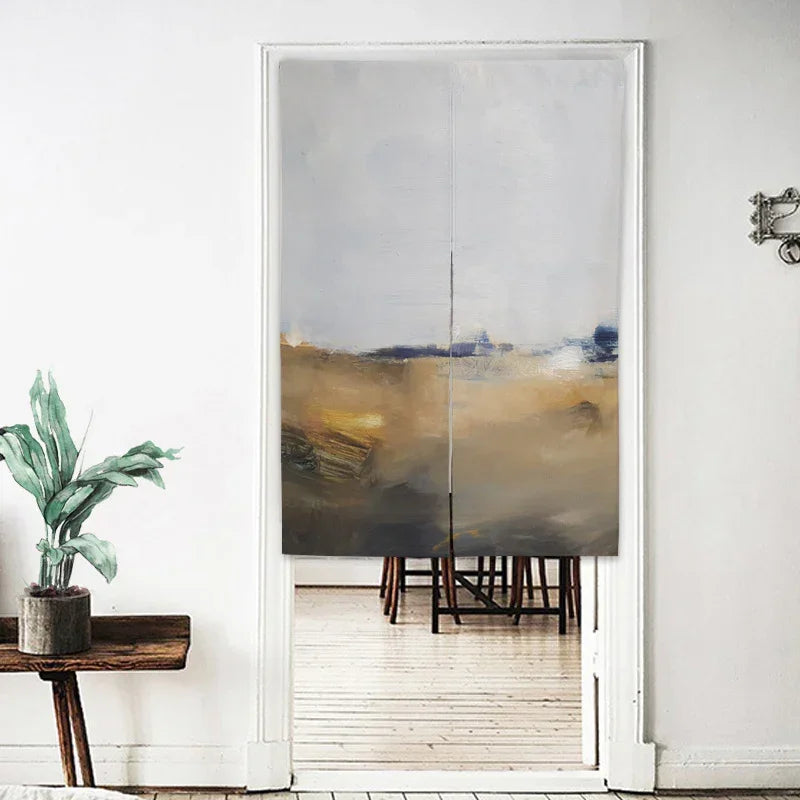 Modern abstract fabric door curtain in beige, gray, and gold tones, hung in a minimalist living space.