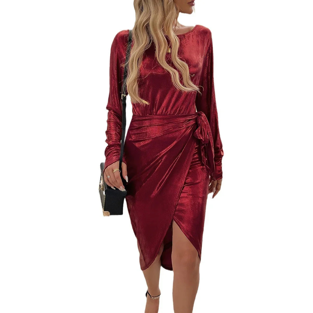 Woman wearing a shiny burgundy velvet long-sleeve wrap dress with side tie and slim fit
