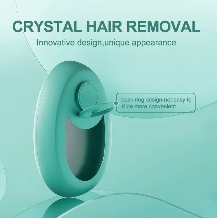 Teal crystal hair remover with ergonomic ring handle and smooth oval design against a light teal background.