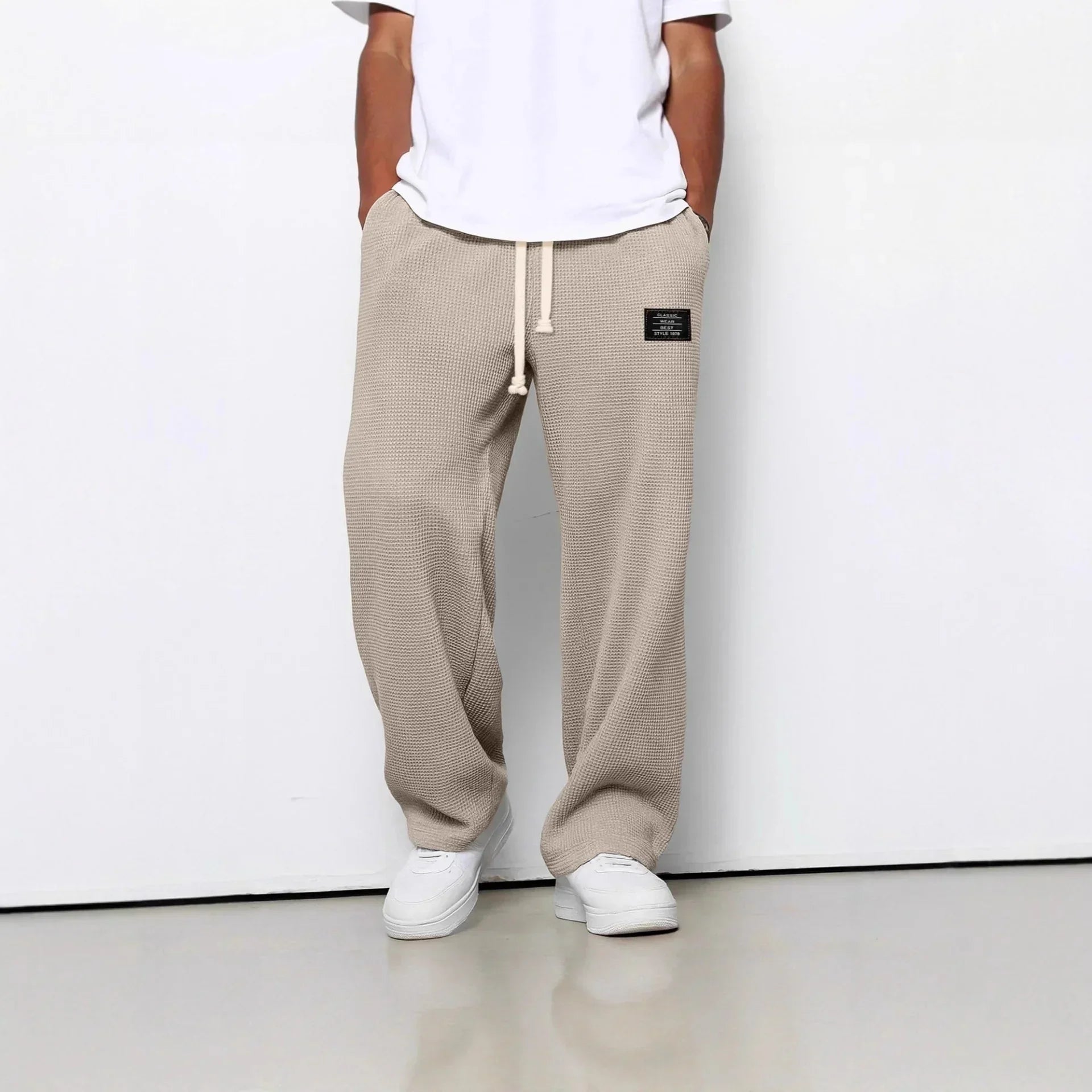 Beige waffle knit drawstring pants, relaxed fit, streetwear style, white sneakers