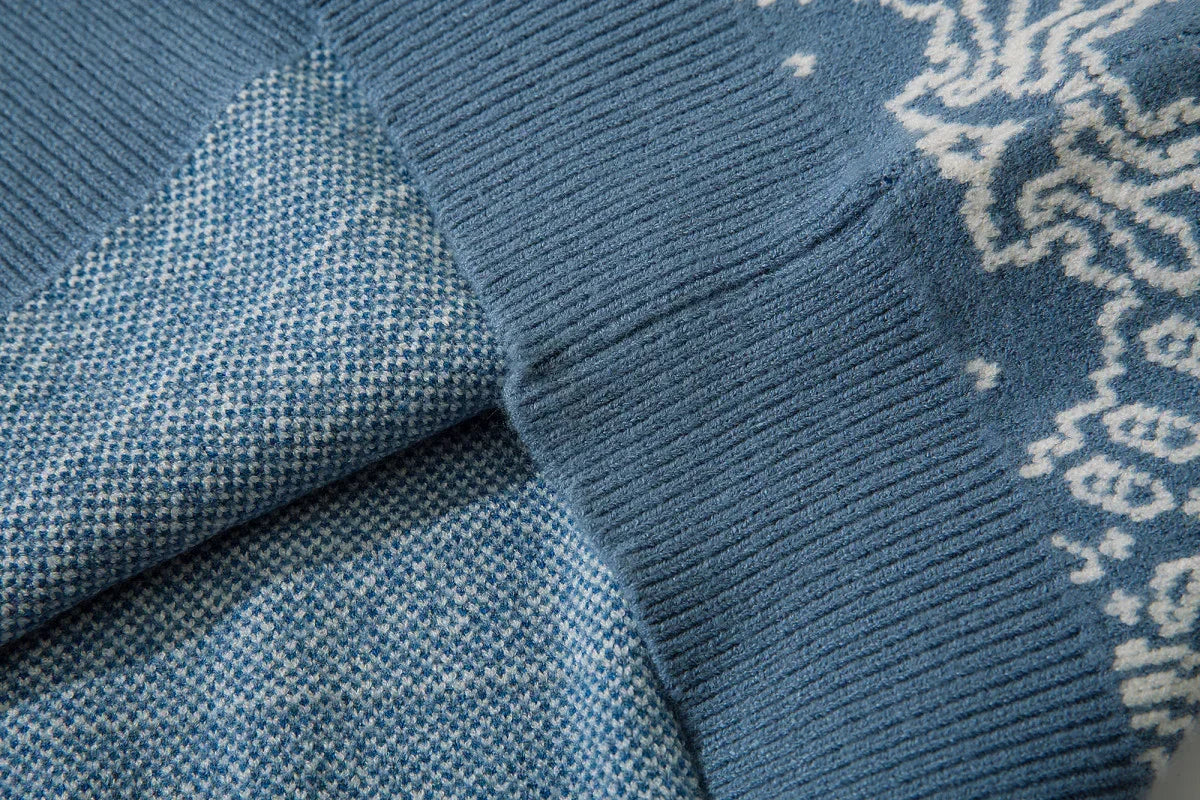 Close-up of blue knit sweater with ribbed cuff and white jacquard pattern, soft texture