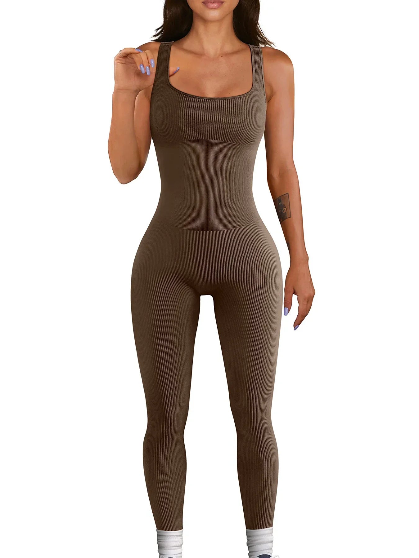 Woman wearing a fitted brown ribbed sleeveless jumpsuit with scoop neckline