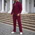 Man wearing a burgundy textured two-piece set with relaxed fit, long sleeves, and white sneakers