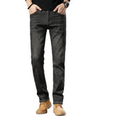 Men’s straight-leg black denim jeans, relaxed fit, paired with tan shoes