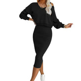 Woman wearing black off-shoulder long sleeve top and fitted midi skirt set, casual style