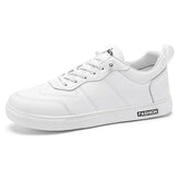 White low-top sneaker with lace-up closure, synthetic leather material, and minimal sporty style