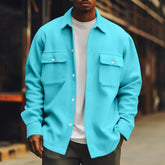 Man wearing oversized turquoise button-up shirt jacket with chest pockets, casual streetwear style