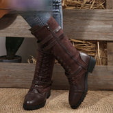 Brown lace-up knee-high boots with leather and suede material, worn with skinny jeans