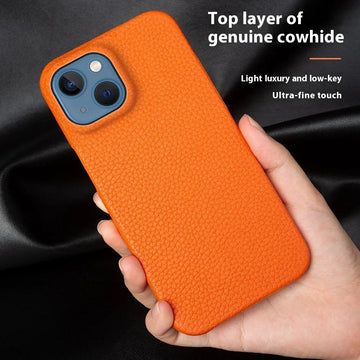 Hand holding an orange genuine leather textured phone case with a slim fit design