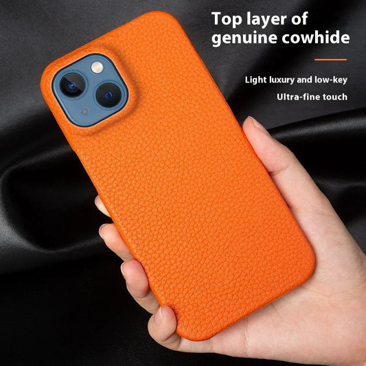 Hand holding an orange genuine leather textured phone case with a slim fit design