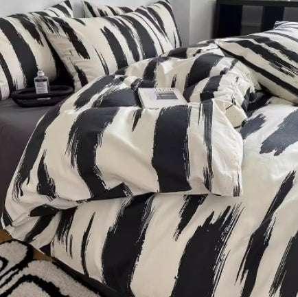 Modern black and white brushstroke pattern bedding set with matching pillow covers, cotton material